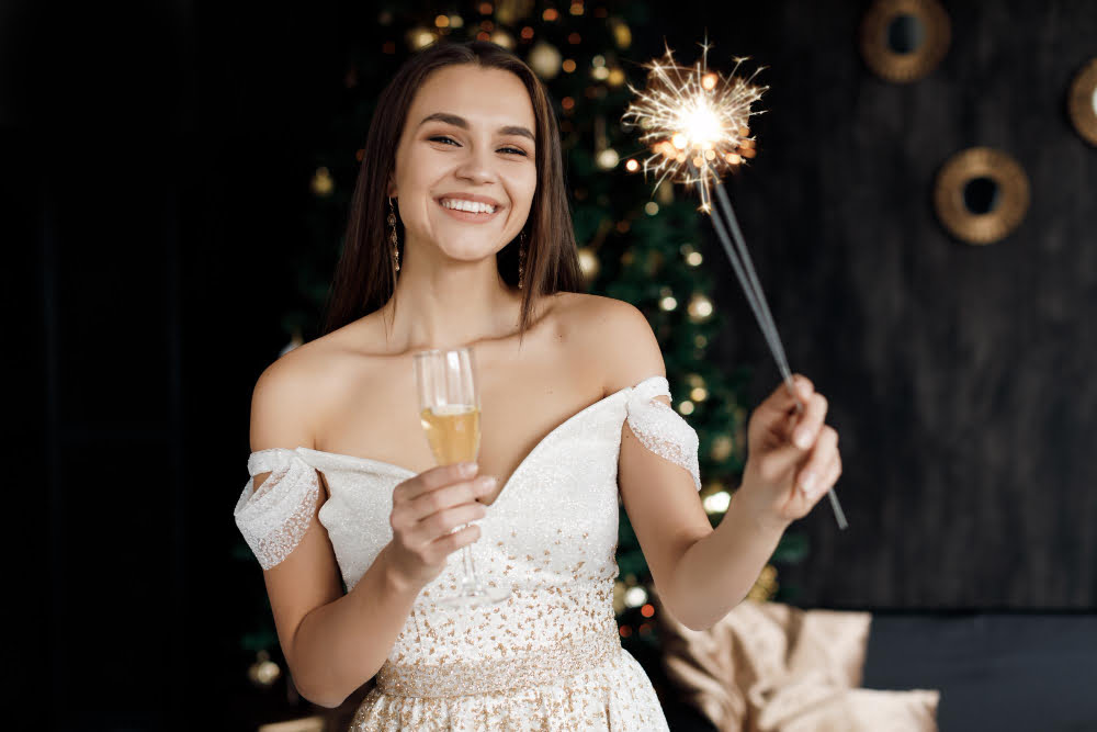 beautiful smiling woman dress with champagne fireworks