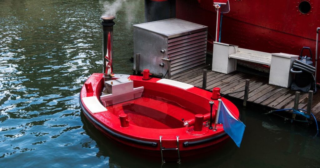 a red hot tub boat at a dock