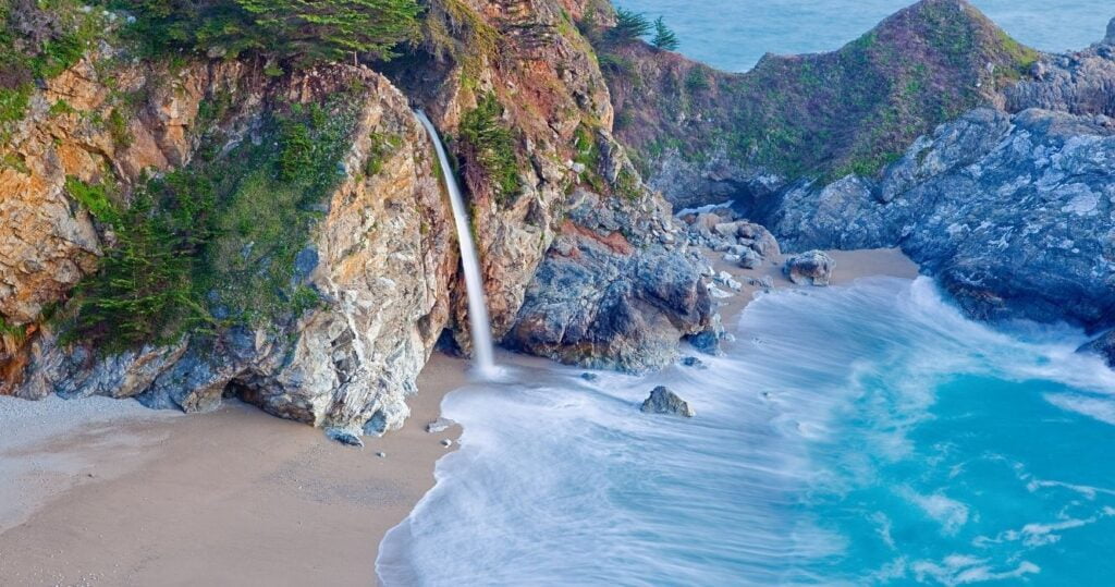 a view of mcway falls in big sur on the pacific coast highway, california