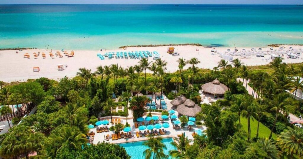 an aerial view of a resort on the ocean